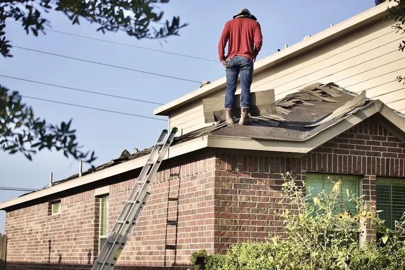 Professional roofer working on a residential roof in Fulton-El Camino